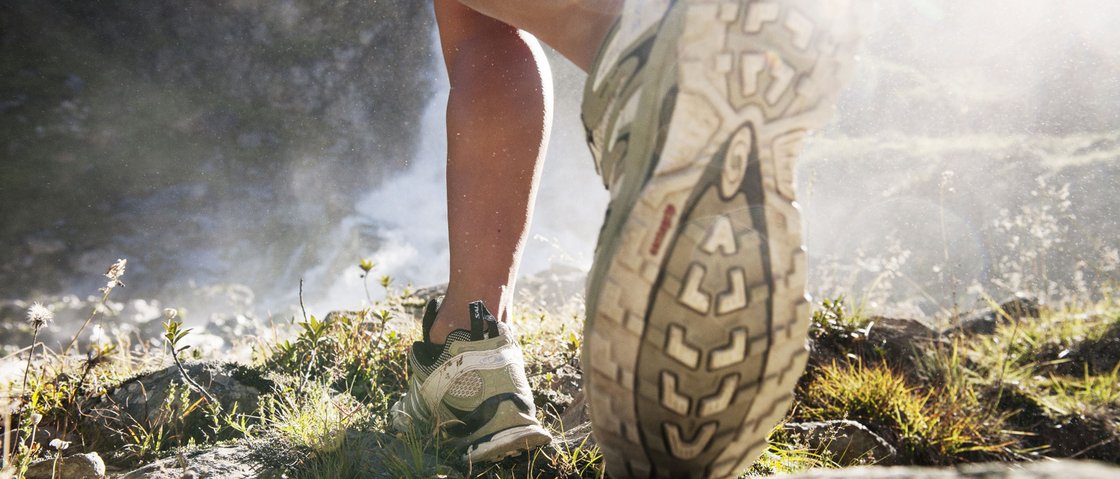 Ready for your holiday in Stubaital this summer? Close-up of a hiker walking on rocky terrain wearing running shoes